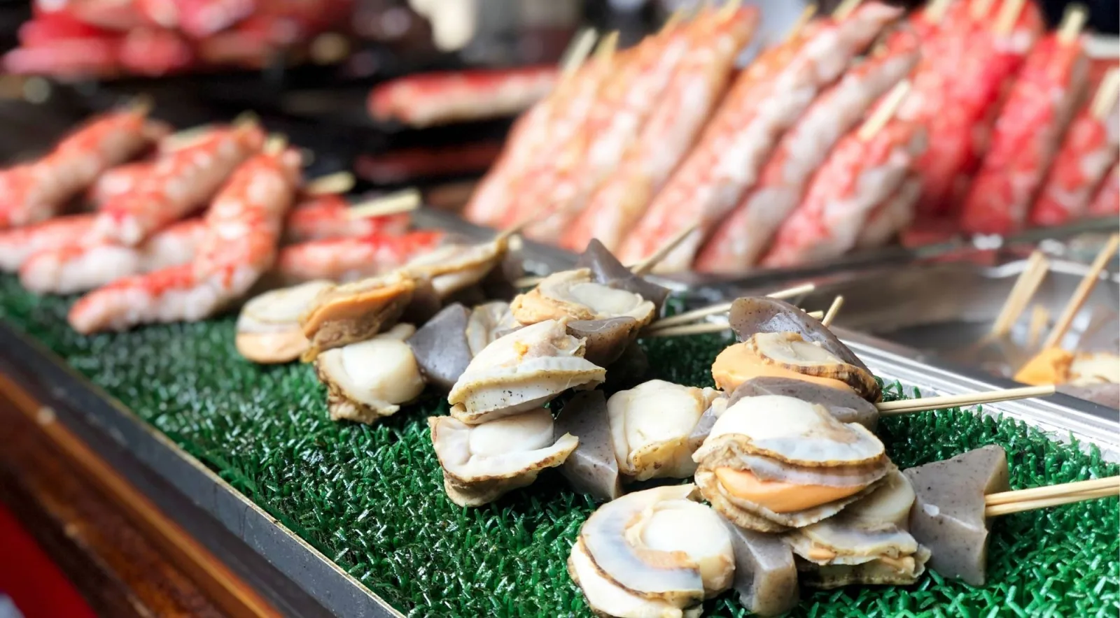 Scallop and crab leg skewers displayed at a Tsukiji outer market seafood stall